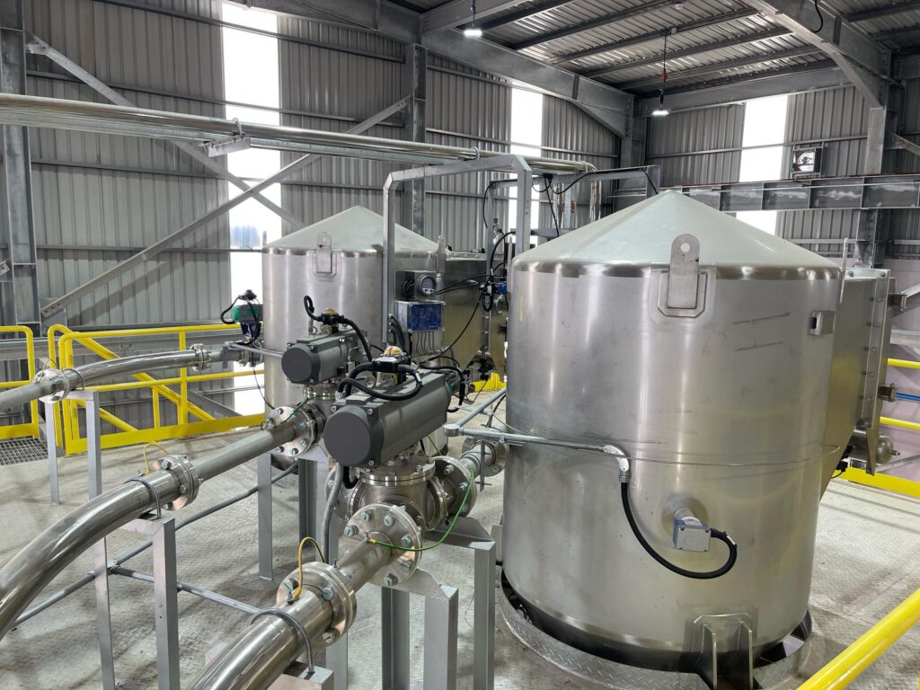 Stainless steel pneumatic conveying equipment in a turnkey material handling setup by Mactex.