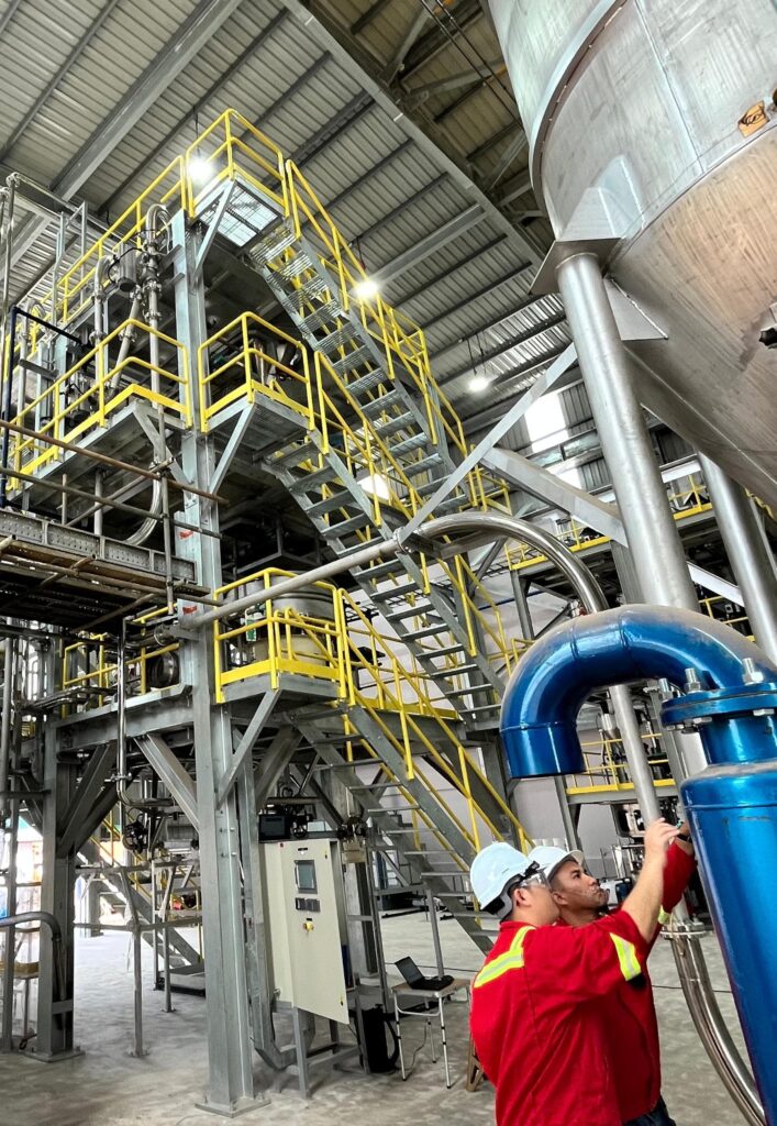 Technicians working on pneumatic conveying system installation under EPCC project scope by Mactex.